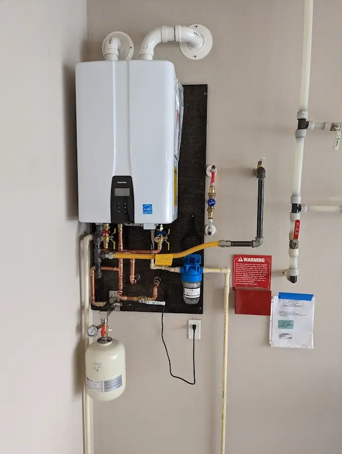 Professional plumber installing copper piping in a East Greenwich home